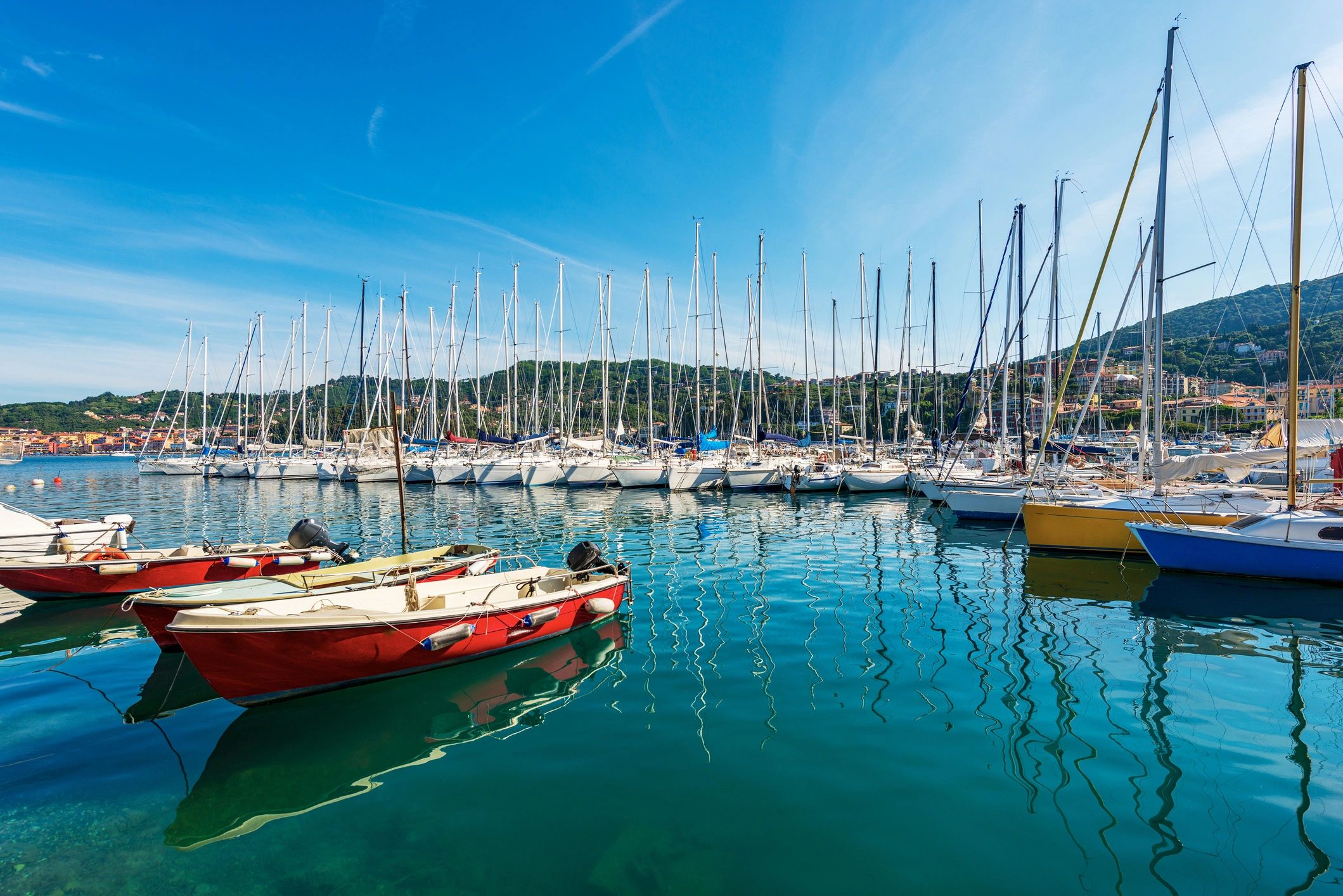 Sailing boats moored in a marina representing boat insurance