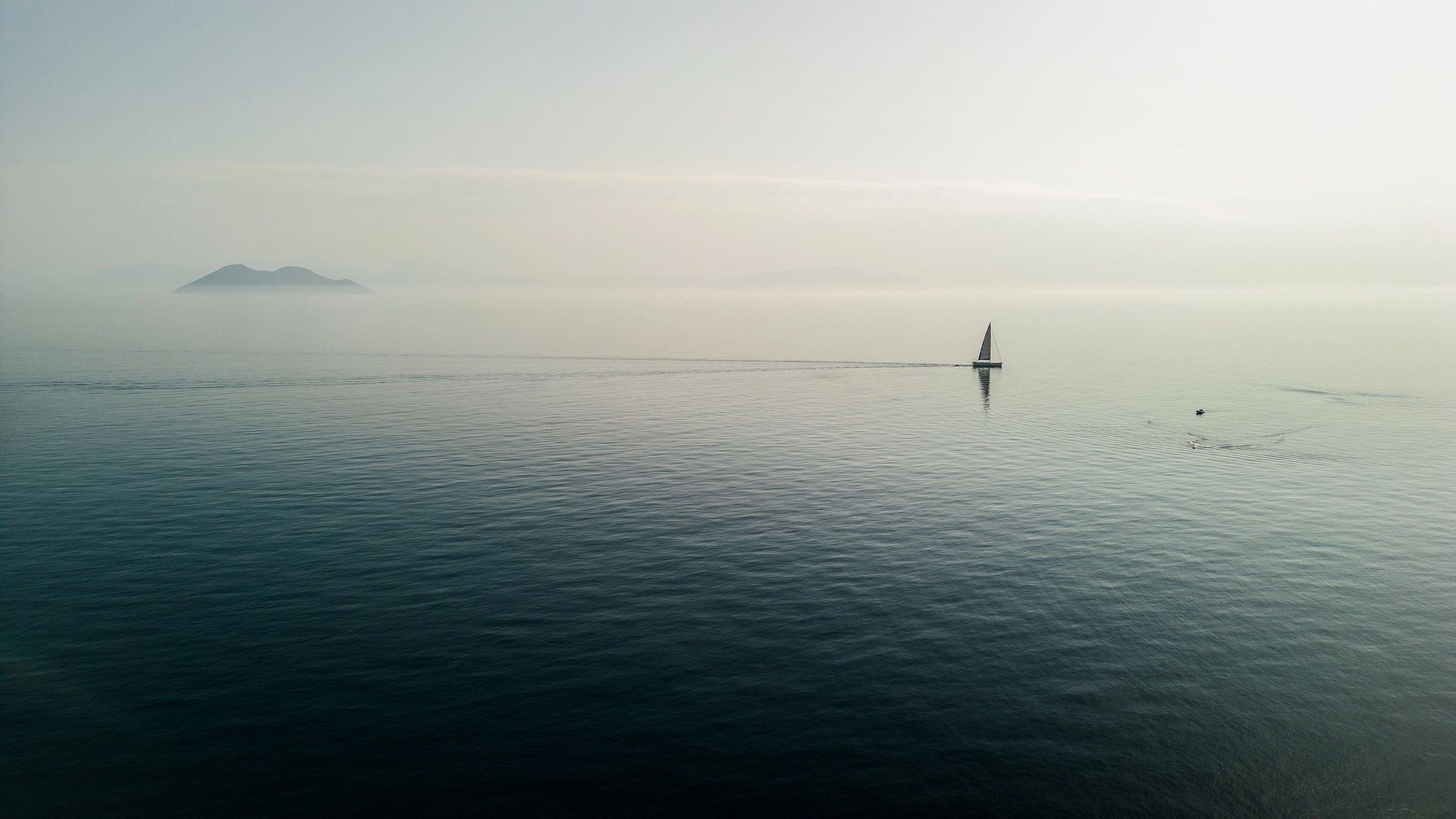Sailboat anchored in a calm bay representing yacht coverage